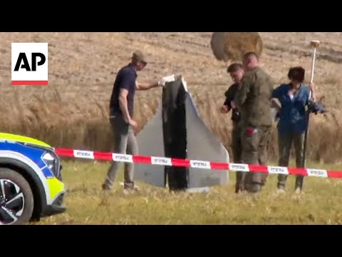 Police secure parts of an object after Russian drones shot down in Poland
